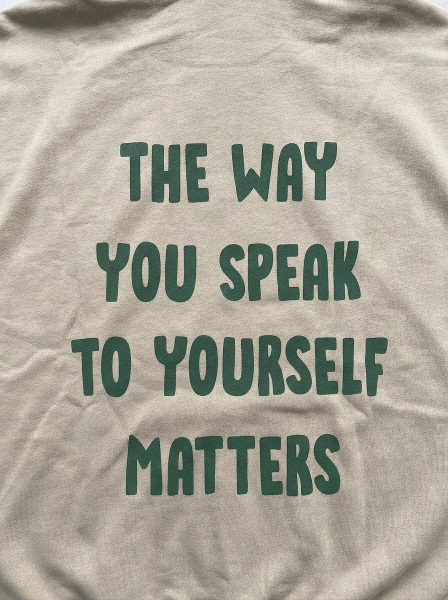 The Way You Speak Hoodie - Beige - back print close-up