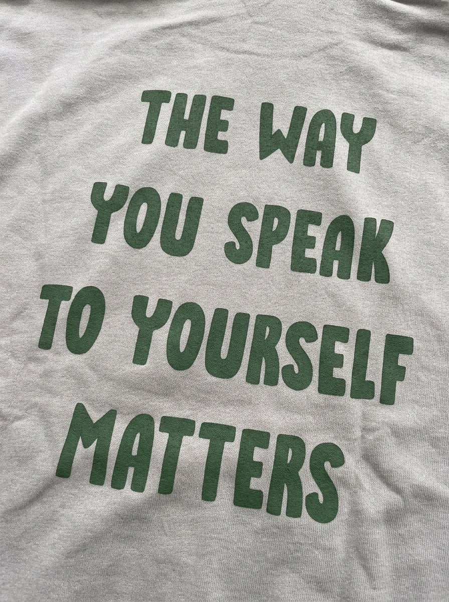 The Way You Speak Hoodie - Silver - back print close-up