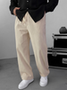 Cream muslin wide-leg trousers styled with black overshirt and white sneakers
