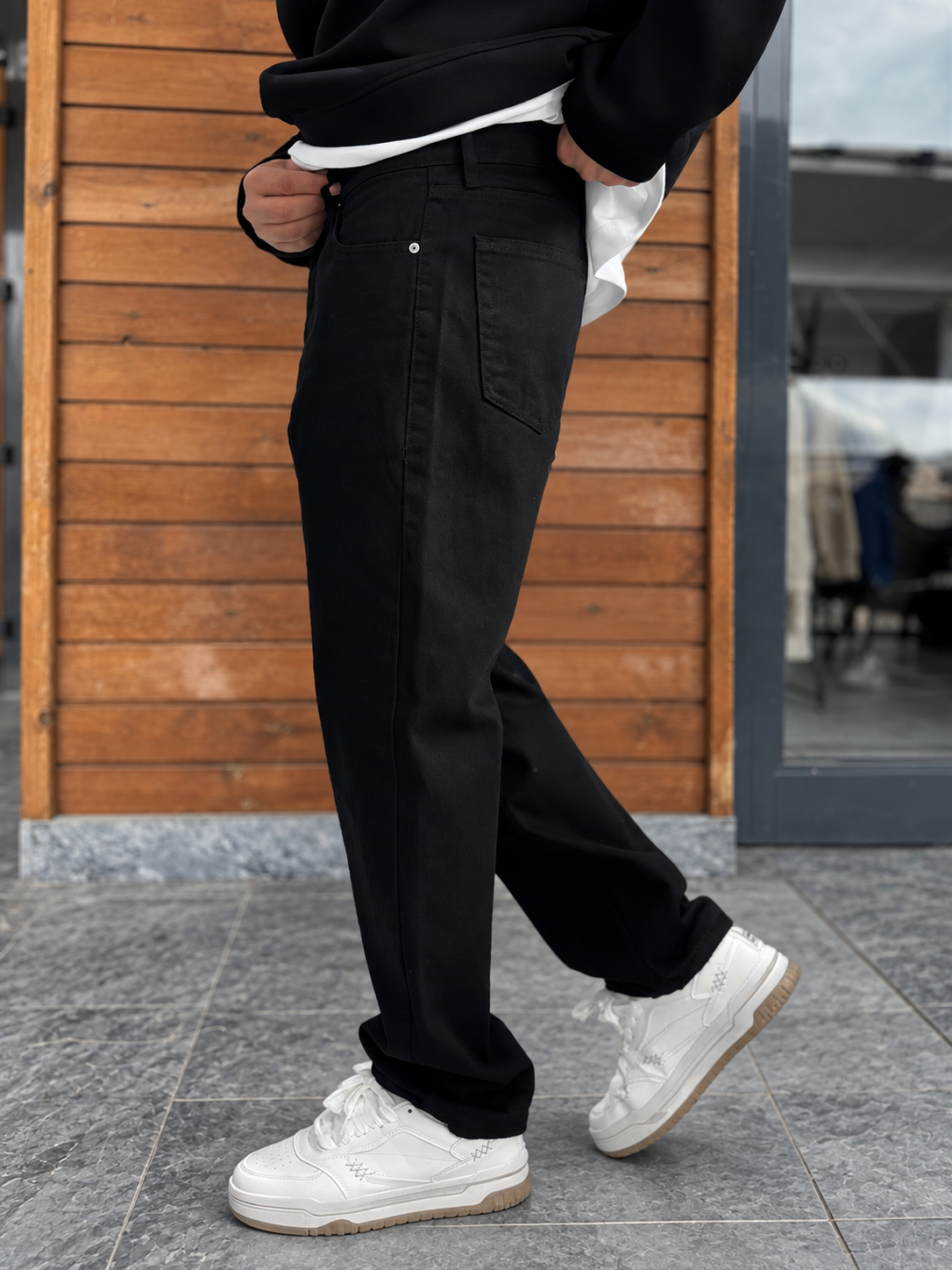 Jet Black Relaxed Fit Denim Jeans by BROEK, side walking view