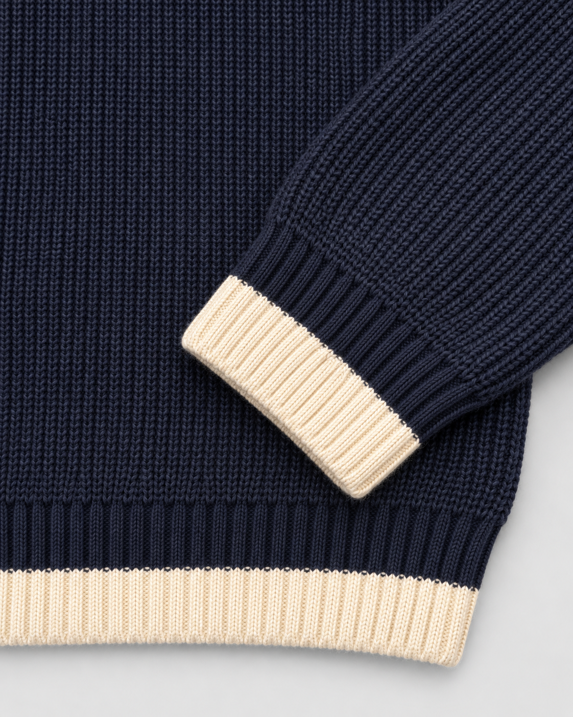 BROEK navy contrast-trim knit sweater — cuff hem detail