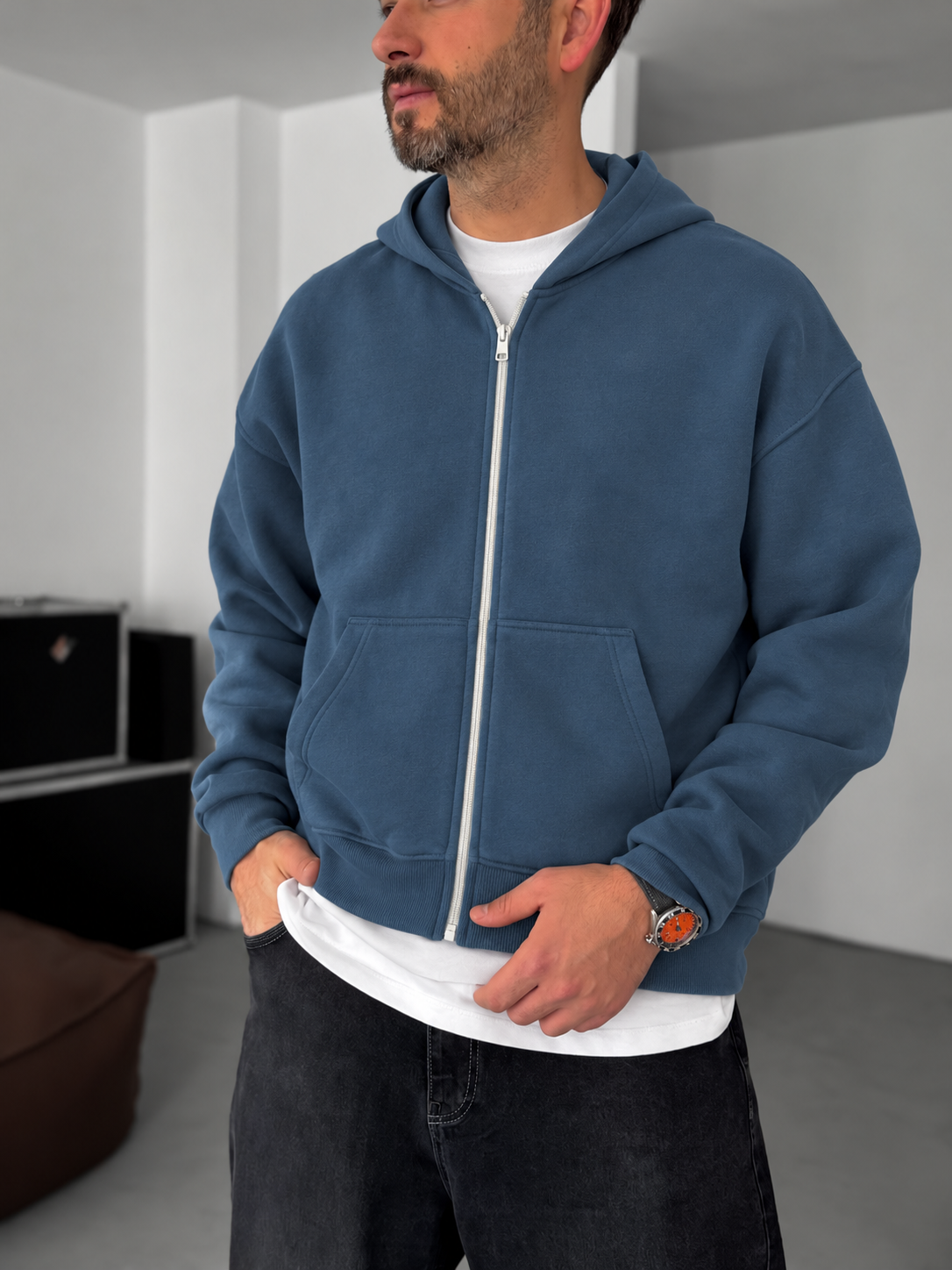 Close-up of BROEK Petrol Blue Zip-Up Hoodie showing the zipper pockets and ribbed hem