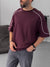 BROEK burgundy oversized T-shirt with white contrast piping, three-quarter model view.