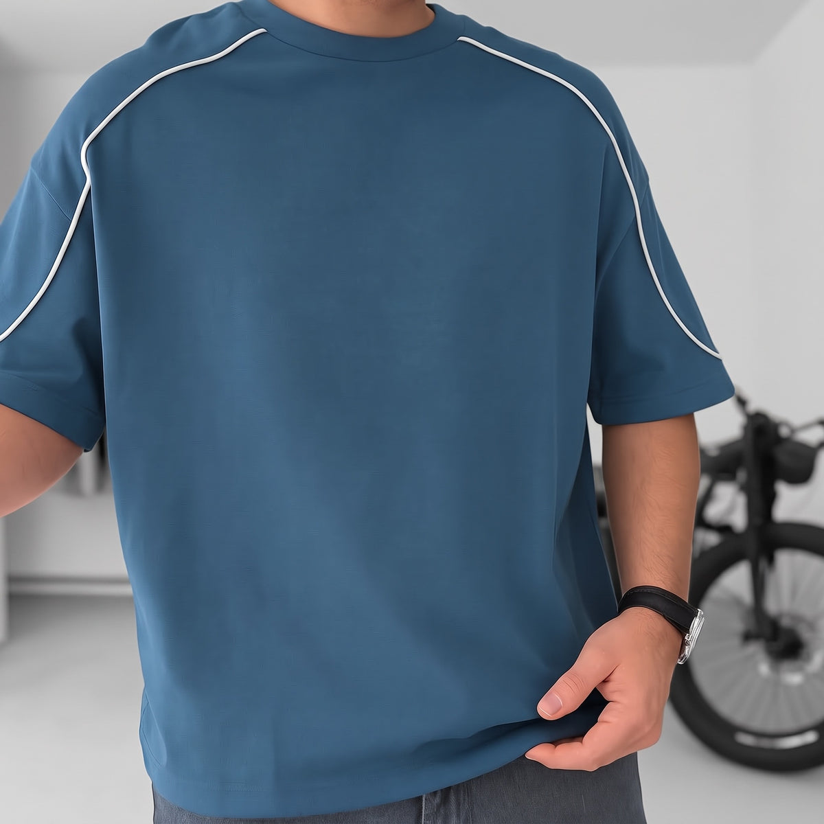 BROEK petrol blue piped oversized T-shirt, close-up of the crew neck, plain front and white piping.