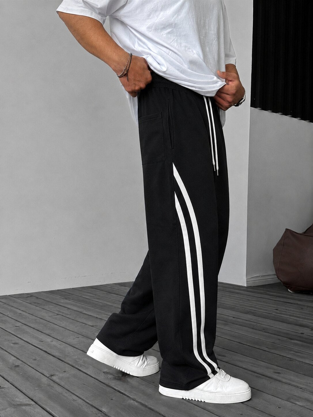 Double Stripe Relaxed Pants in black, rear side view