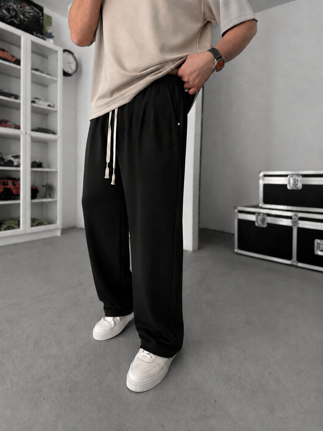 Pleated Relaxed Sweatpants in black, angled view