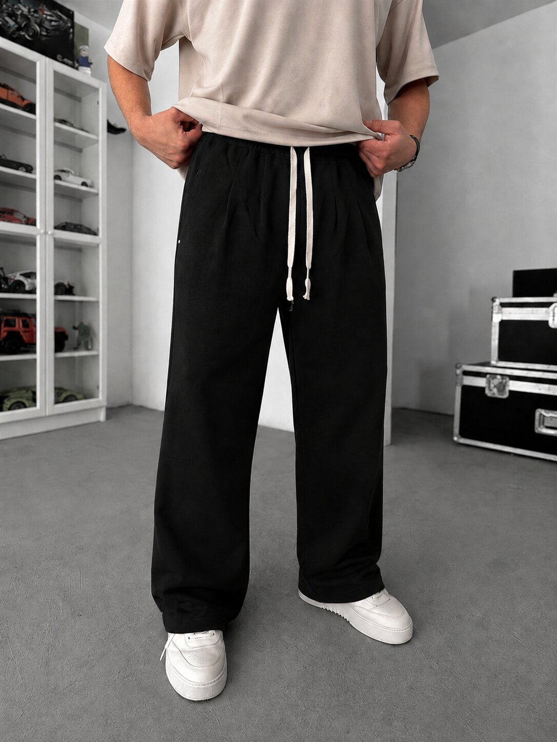 Pleated Relaxed Sweatpants in black, front view